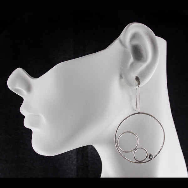 Large sterling silver hoop earrings with gemstones by eko jewelry design on model-Trelany