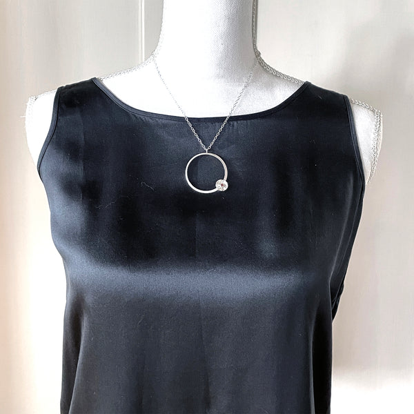 Silver flower hoop necklace with garnet by eko jewelry design, Cleanthe on model