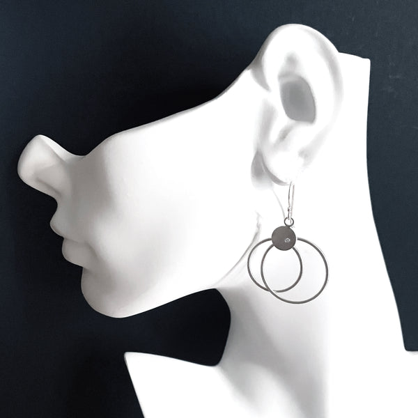 Silver double hoop earrings with diamonds by eko jewelry design, Rhea on model