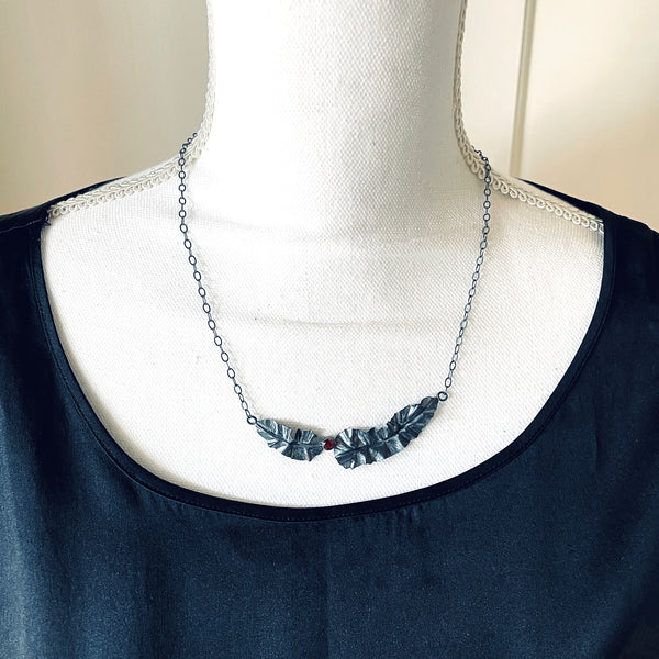 silver leaf necklace with garnet on model by eko jewelry design, Bren