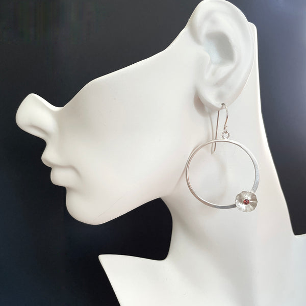 Silver flower hoop earrings with garnet by eko jewelry design, Kliantha  on model